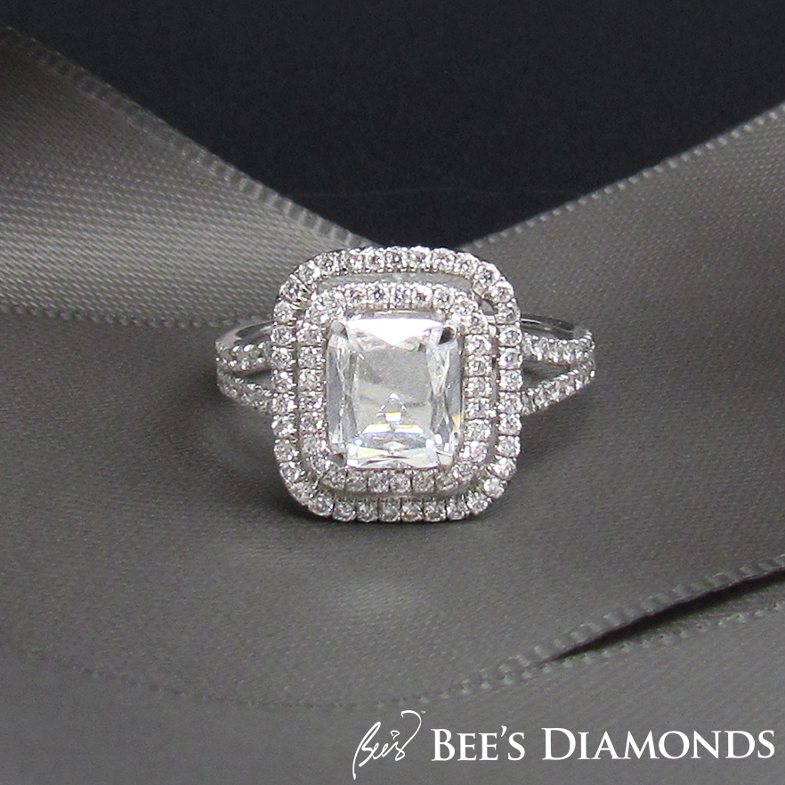 Rectangular, cushion, rose cut diamond ring with two halos of small diamonds