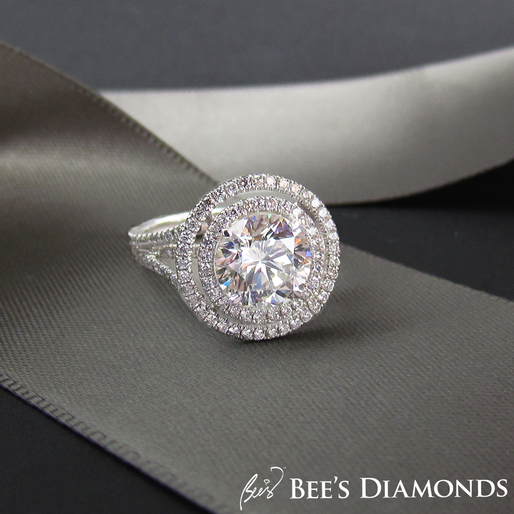Large round brilliant cut diamond with halos of small diamonds
