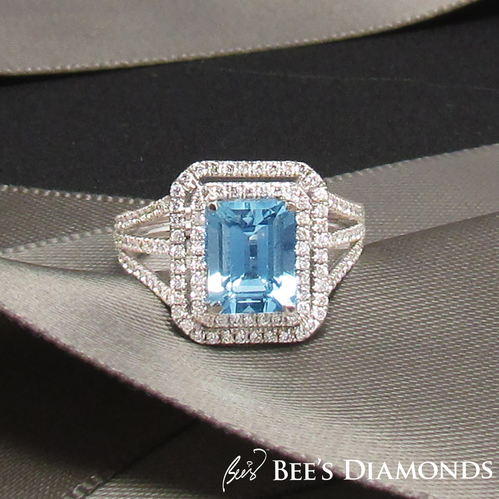 Aquamarine emerald cut ring with halos of small round diamonds